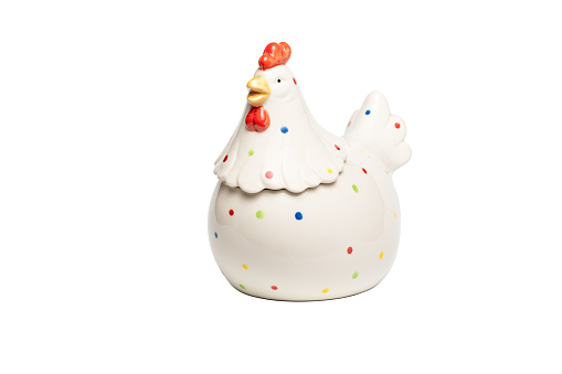 White ceramic rooster figurine with colored dots on body feathers isolated on white background. Concept of home decoration, happy Easter, year of cock.