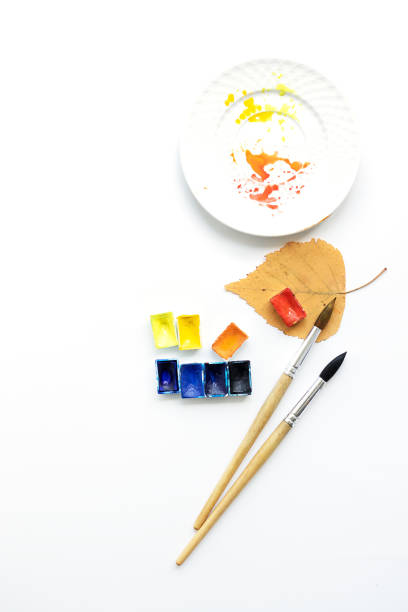 istock Happy autumn. Workplace with a plate, pens and watercolor palette, flat composition. 1223896600