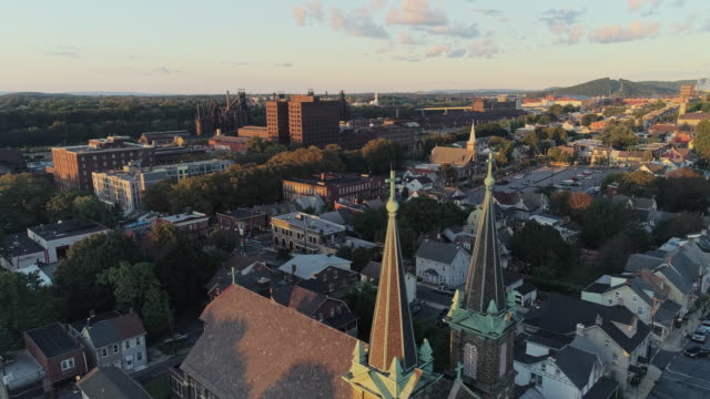 Panoramic scenic view of Bethlehem, Pennsylvania, at sunset. St Joseph's CR Church. Aerial drone video with the forward-panoramic complex cinematic camera motion.