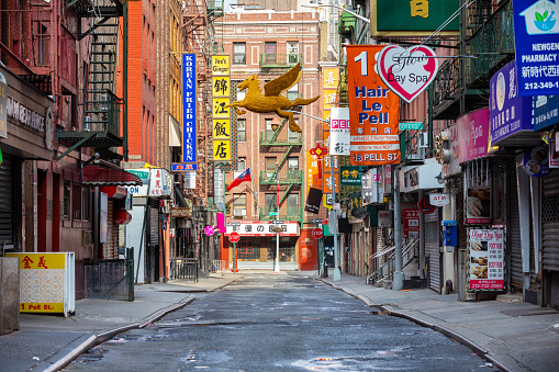 Manhattan, New York, USA - 4/25/2020: normally busy streets of chinatown empty of crowds during the New York City coronavirus pandemic lockdown.