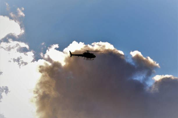 istock Helicopter among clouds in the sky in late afternoon 1223898067