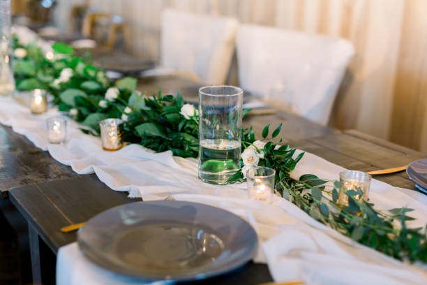 istock Olive branches and Eucalyptus Leaves  Decorating the Head Table at a Wedding Reception, Gray Table with Gray Plates on a White Cheese Cloth, Table Scape Design. 1223898737