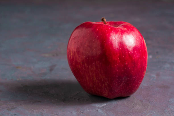 istock An isolate apple on a gray table. Delicious and healthy fruit. 1223901622