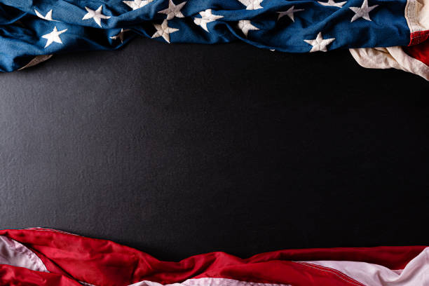 istock Happy Memorial Day. American flags with the text REMEMBER & HONOR against a black  background. May 25. 1223903118