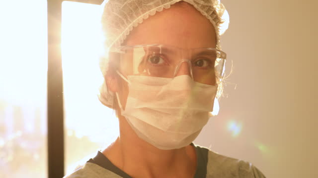 Female health care worker portrait with sun on background