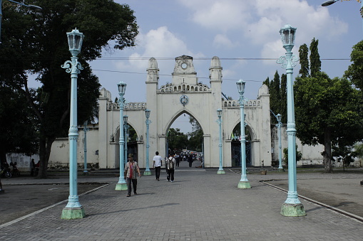 Gate of Great Mosque of Surakarta Palace under cloudy blue sky. The Great Mosque of the Surakarta Palace was built by Sunan Pakubuwono III in 1763 and was completed in 1768. The mosque is located in complex of Surakarta Sutanate Palace, Surakarta, Indonesia.
