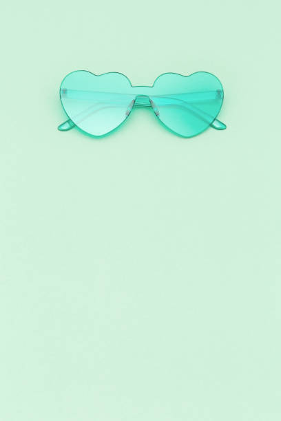 istock Stylish heart shaped glasses on mint green colored background with copy space. Beautiful trendy sunglasses. Fashion summer concept. 1223908174
