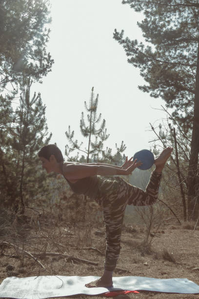 istock Mature Woman doing pilates exercises in the forest 1223910610