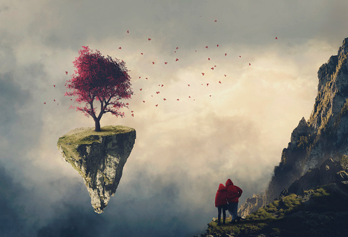Couple on a mountain cliff looking at a floating island with a red tree .