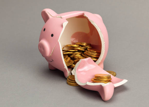 Broken piggy bank with coins