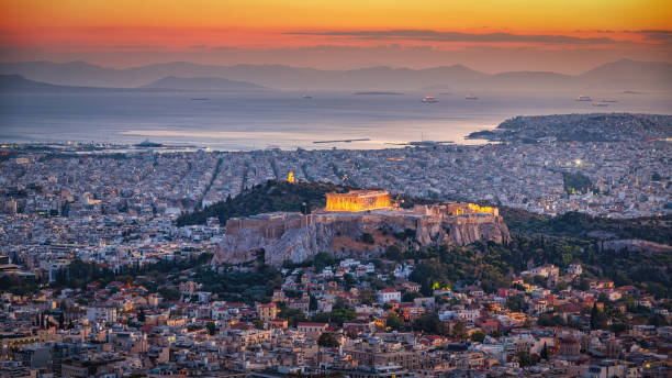 Athens Cityscape in Sunset Light Panorama View over the greek capital city of Athens with the famous Acropolis in Sunset Twilight. Athens, Attica, Greece, Southeast Europe acropolis athens stock pictures, royalty-free photos & images