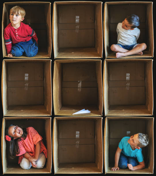 istock Lost Toy Interaction Small Children Inside Enclosure Series Involving Cardboard Box Related to Shelter In Place During Illness Crisis 1223921168