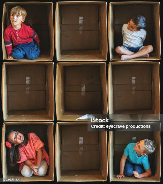 Lost Toy Interaction Small Children Inside Enclosure Series Involving Cardboard Box Related To Shelter In Place During Illness Crisis Stock Photo - Download Image Now