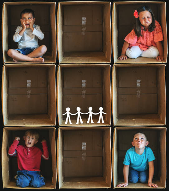istock Separated from Social Interaction Small Children Inside Enclosure Series Involving Cardboard Box Related to Shelter In Place During Illness Crisis 1223922167