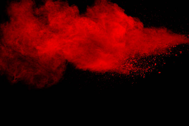 istock Red particles explosion on black background. Freeze motion of red dust splash. 1223922852