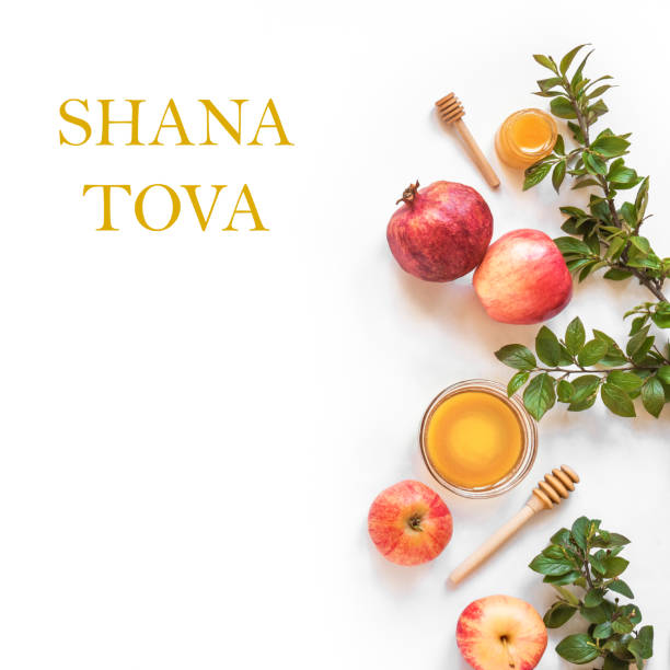 Rosh Hashanah Rosh Hashanah jewish New Year holiday concept. Creative layout of traditional symbols - apples, honey, pomegranate isolated on white, top view, copy space. jewish new year stock pictures, royalty-free photos & images