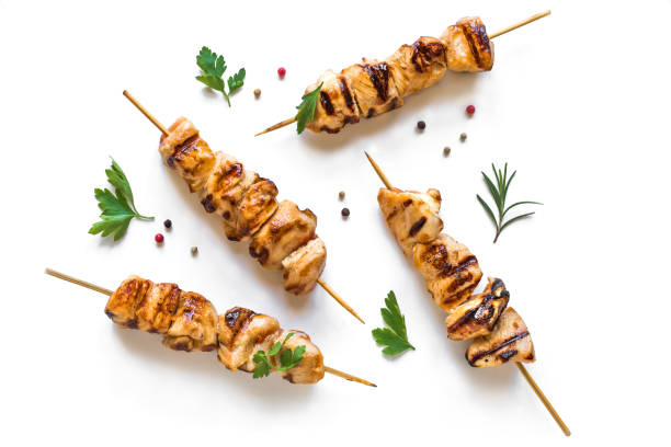 Grilled chicken skewers Grilled chicken skewers isolated on white background, top view. Meat pork, chicken or turkey shish kebab with herb and spices. chicken skewer stock pictures, royalty-free photos & images