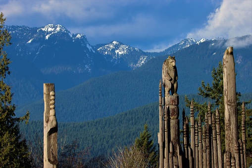 Totem poles on top of the Burnaby Mountain in January 2020, British Columbia, Canada.\nAt the top of the mountain, is “Kamui Mintara” or “The Playground of the Gods”, the totem poles were built to honour the Sister City relationship between Burnaby and Kushiro, Japan.