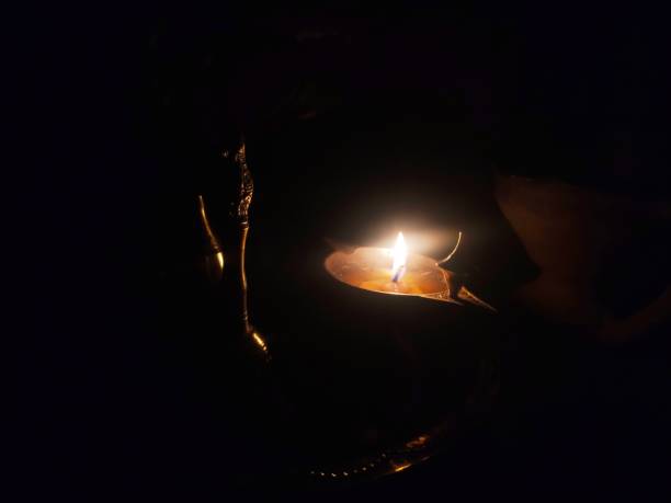 istock oil lamp in dark room 1223926847