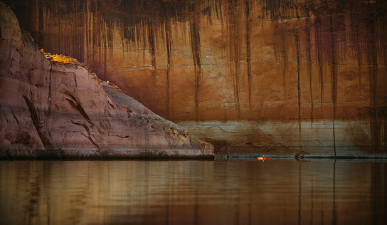 Beautiful view of sandstone wall reflection and water at Lake Powell reservoir in Utah and Arizona.  Part of Colorado River in the Glen Canyon National Recreation Area.