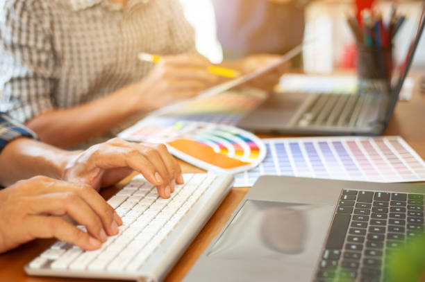 istock The design team is designing colors and working with laptops. 1223930508