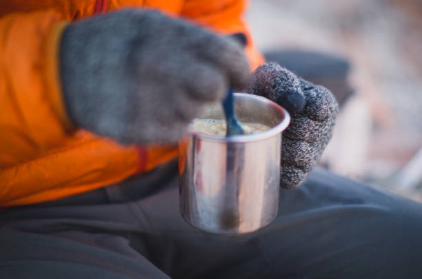 istock Man wearing gloves stirring a coffee cup 1223931318
