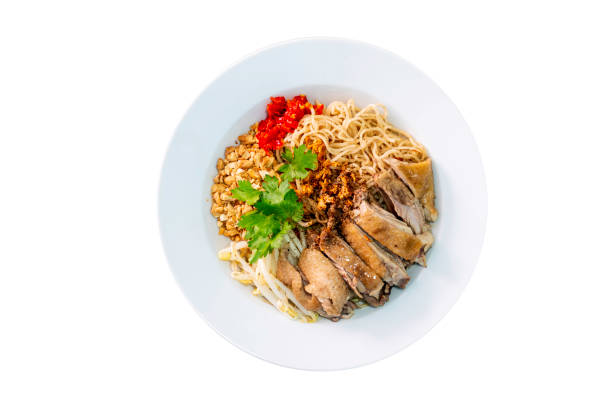 Dry duck noodle in white plate on isolated white background. Top view.
