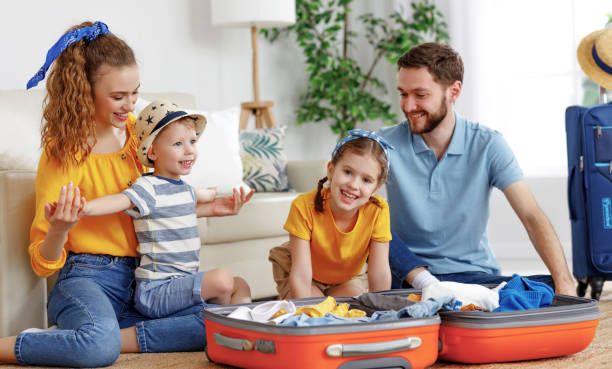 istock Cheerful family with suitcases on floor 1223936254