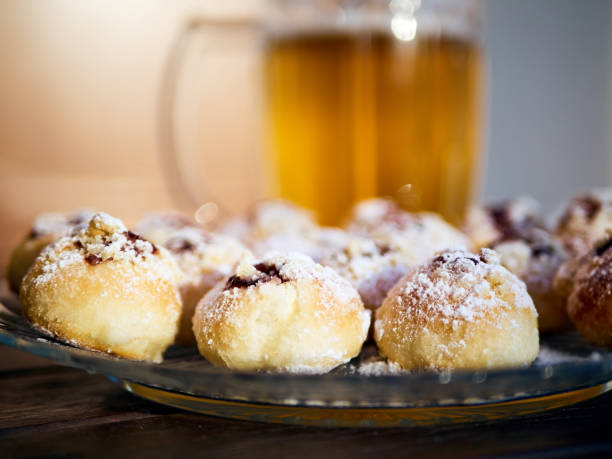 Czech wedding pastry - kolache Czech wedding pastry sprinkled with sugar, pint of beer in the background. kolache stock pictures, royalty-free photos & images