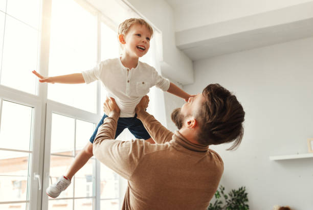 istock Happy man with little son having fun at home 1223936524