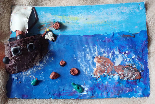 istock plasticine ship and items in the sea, on the waves 1223939262