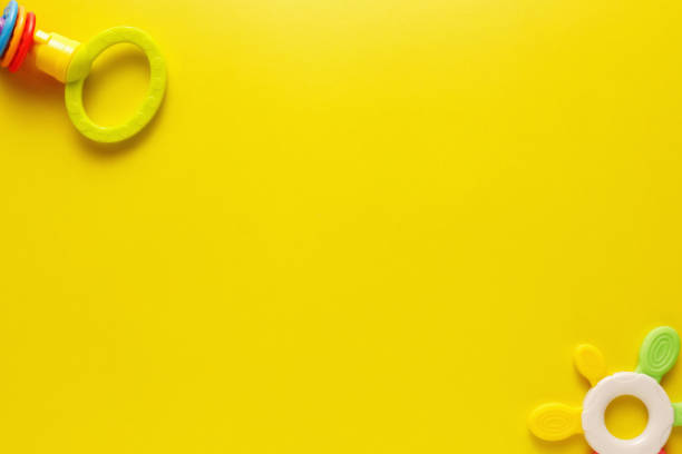 istock Colorful and various plastic toys for babies on a yellow background. Layout. Empty space for the text. Minimalism 1223939352