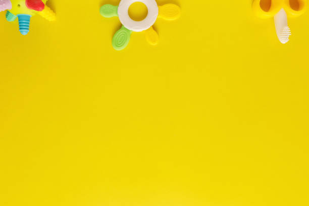 istock Colorful and various plastic toys for babies on a yellow background. Layout. Empty space for the text. Minimalism 1223939946