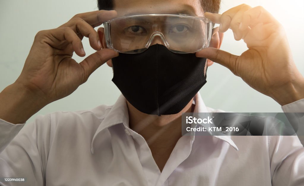 Businessman wearing safety google and mask to protect virus COVID-19. Stay home, Work from home, Social Distance Concept. 35-39 Years Stock Photo