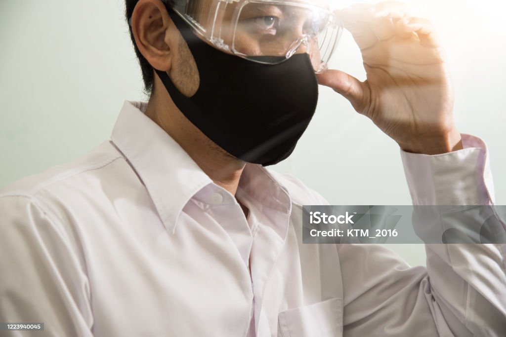 Businessman wearing safety google and mask to protect virus COVID-19. Stay home, Work from home, Social Distance Concept. 35-39 Years Stock Photo