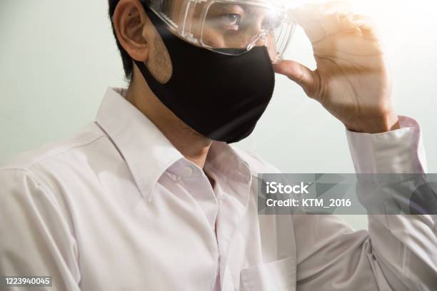 Businessman Wearing Safety Google And Mask To Protect Virus Covid19 Stay Home Work From Home Social Distance Concept Stock Photo - Download Image Now