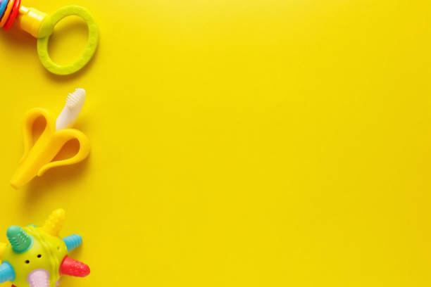istock Colorful and various plastic toys for babies on a yellow background. Layout. Empty space for the text. Minimalism 1223940140