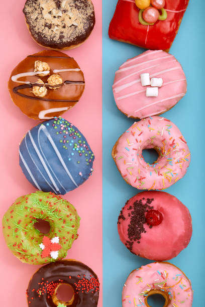 istock Sweet donuts on a blue and pink background. Assorted donuts, border color blue pink background 1223940201