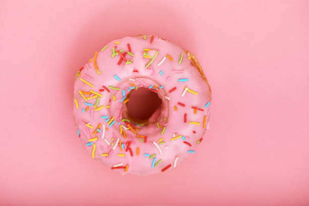 istock Pink donut on a pink background, minimalism concept, color game.background, copy space 1223940250