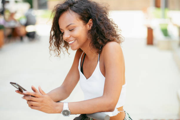 istock Beautiful african girl using phone outdoors. 1223941237