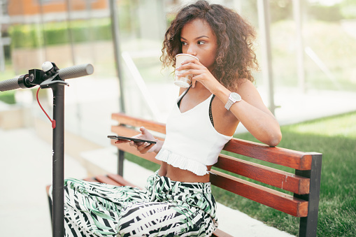 Beautiful african girl outdoors. Young girl with curley hair enjoying in the park.