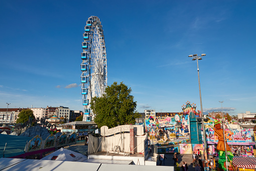 Wide shot aerial view of an outdoor travelling carnival with different rides and food stalls in the North East of England.\n\nVideos are available similar to this scenario.