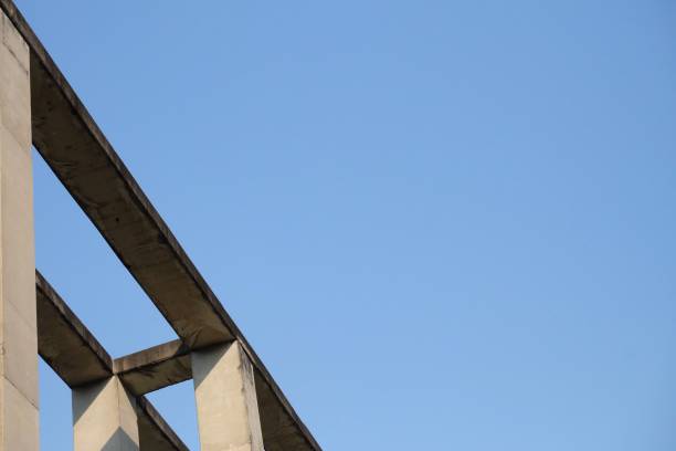 istock High rise view strong structure of high building against blue sky and sun light 1223942050