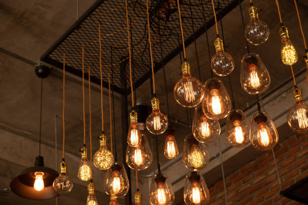 istock Beautiful vintage luxury light bulb hanging decor glowing in dark. 1223944728