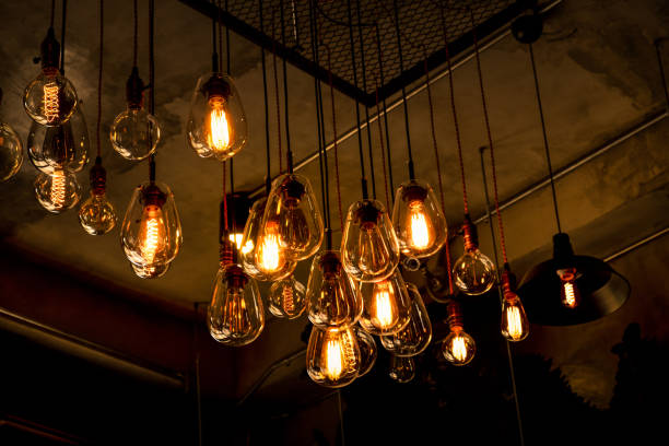 istock Beautiful vintage luxury light bulb hanging decor glowing in dark. 1223944733