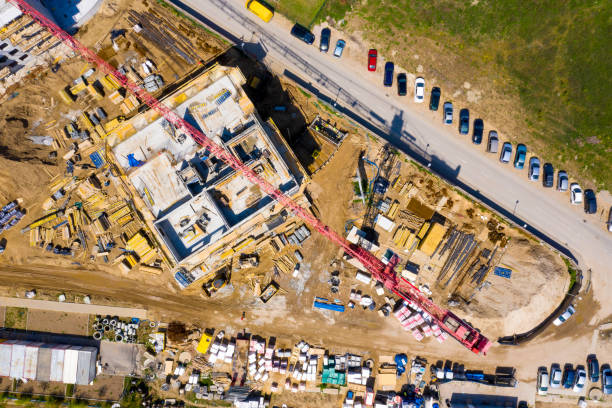 istock Construction site with cranes. Construction workers are building. Aerial view of construction site of residential area buildings with cranes 1223945743