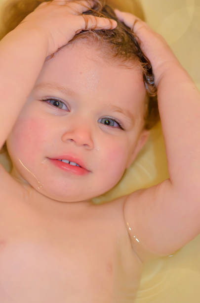 istock cute baby girl playing in her bath 1223947101