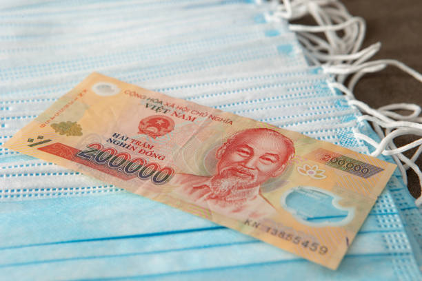 istock Vietnamese currency with face mask 1223948221