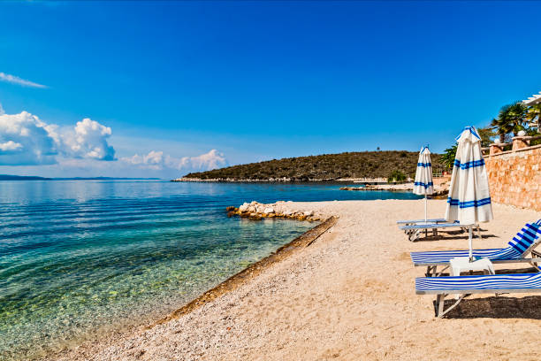 istock Empty beach with beach umbrellas closed. Beautiful cloudy sky. Beach with no travellers and tourists. Cancellations due to coronavirus covid-19. Quarantine. 1223948657