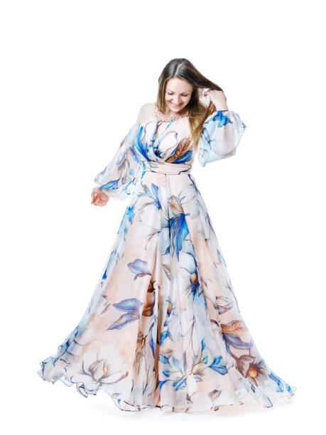 istock Girl in a long chic dress dancing on a white background 1223949964